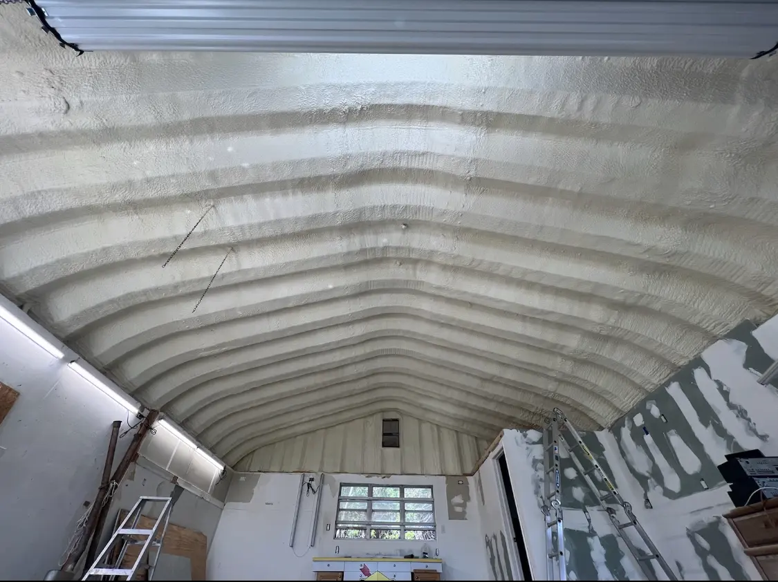 Spray polyurethane foam applied to the underside of a metal roof deck in The Village